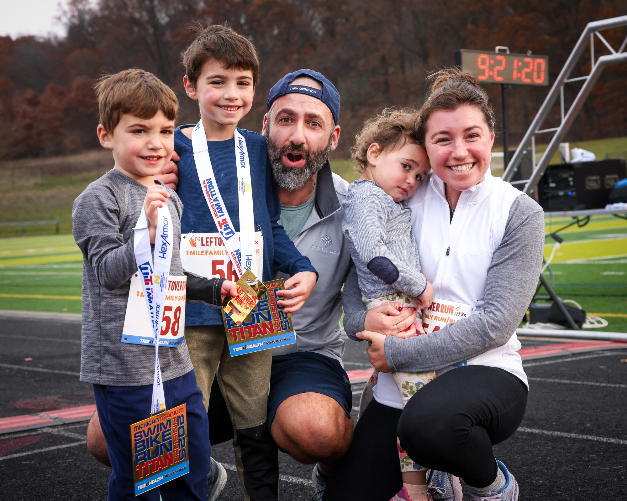 A family with children showing their Leftover Run medals